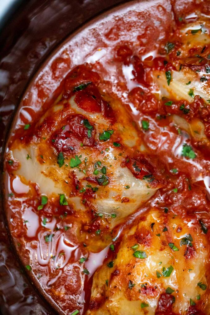 overhead shot of slow cooker stuffed cabbage rolls in a tomato sauce broth