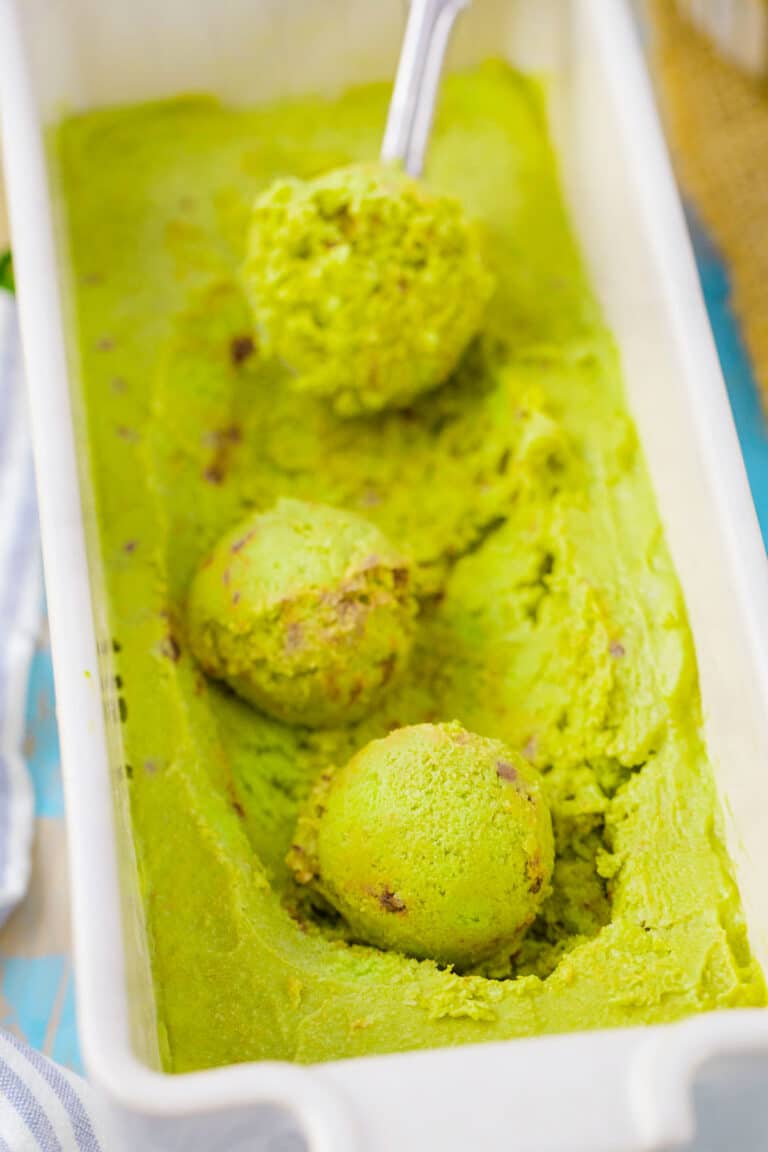 Mint chocolate chip avocado ice cream balls in a ceramic dish.